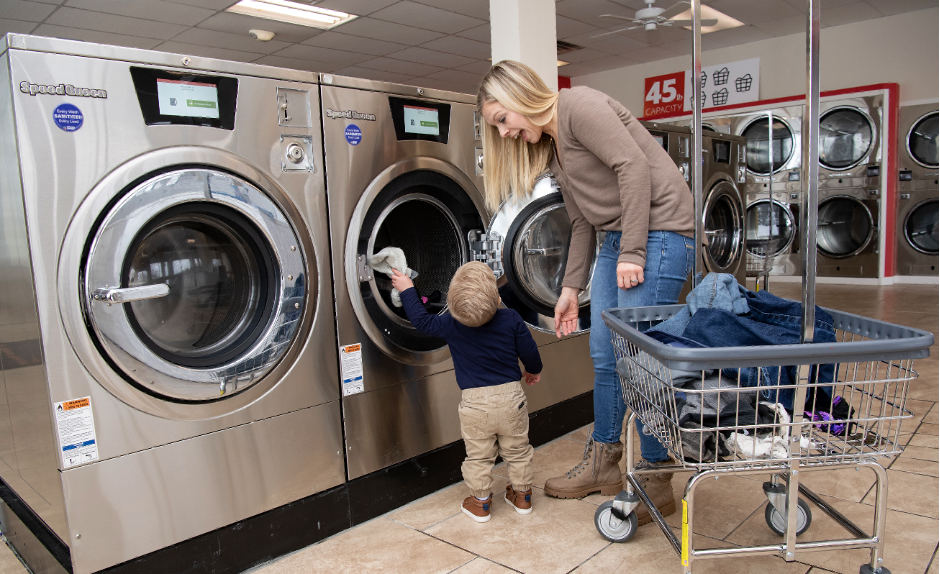 Person and child looking at washing machines